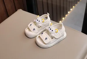Detail of baby summer sandals featuring cartoon bear design and secure velcro straps