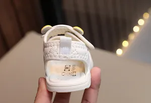 Detail of baby sandal showing quilted texture, heel pull tab and bear logo insole
