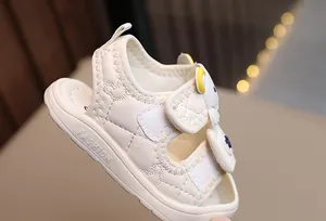 Detail of baby summer sandals featuring quilted faux leather and cute cartoon velcro strap