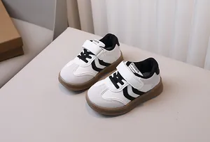 Detailed shot of kids classic trainers with white faux leather and brown gum soles