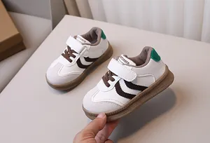 Close-up of kids leather sneakers with velcro straps and brown non-slip rubber soles