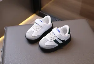 Detail view of retro toddler sneakers with suede toe, green stripes and velcro strap