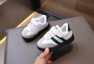 Close-up of kids trainers featuring velcro straps and non-slip gum soles in detail