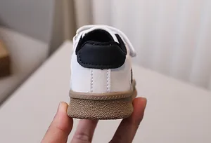 Detail of the non-slip rubber sole and leather heel on children's casual sneakers