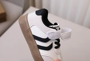 Detail view of children's sneakers with magic tape straps and non-slip rubber soles