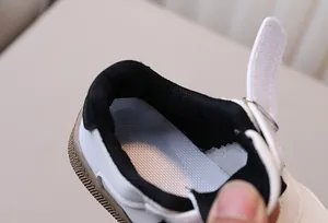 Detailed view of breathable mesh insole and velcro strap on kids' casual sneakers