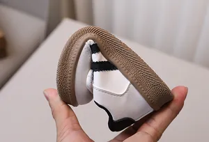 Close-up of flexible brown gum sole on kids casual sneakers showing high durability