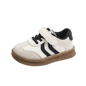 Beige children's sneakers with black stripes and brown non-slip rubber soles for kids