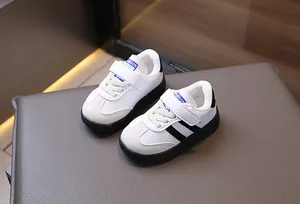 Detail of toddler sneakers with white faux leather, hook-and-loop straps and rubber sole
