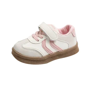Detail view of pink stripes and textured rubber sole on children's minimalist sneakers