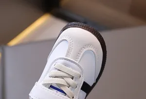 Detail of the suede T-toe design and durable rubber sole on toddler sneakers