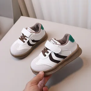 Kids vintage casual sneakers with velcro straps and brown rubber sole in white and green