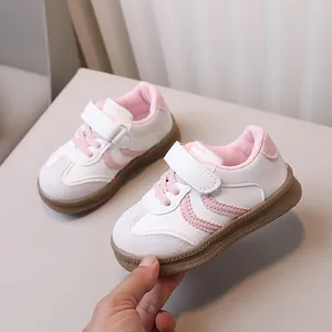 Pink and white casual children's sneakers with velcro straps and brown gum anti-slip soles