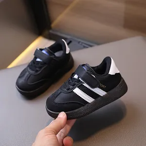 Classic black and white toddlers' athletic shoes with velcro straps and rubber soles