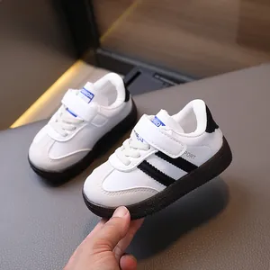 Classic white toddler sneakers with black stripes and non-slip rubber soles for boys and girls