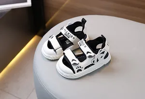 Detail of baby summer sandals featuring dual hook-and-loop straps and anti-slip rubber soles