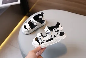 Detail of baby summer sandals featuring panda paw prints and adjustable velcro straps