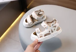 Detail of baby summer sandals featuring a cute bear cutout and double velcro straps