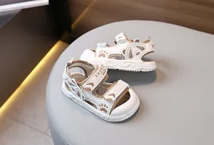 Detail view of toddler sandals with double velcro closure and anti-slip thick white sole