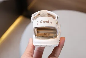 Close-up of baby leather sandals featuring panda text detail and soft padded heel support