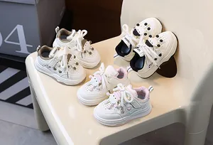 Dettaglio di scarpe da ginnastica per bambini con bambole pecore 3D e cuori intagliati