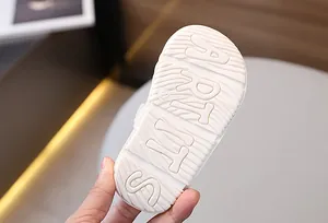 Close-up of the anti-slip soft rubber outsole with wave texture and size 22 on baby sandals