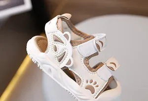 Detail of baby summer sandals featuring closed-toe design with animal print and velcro straps