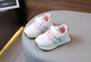 Detailed view of kids sneakers featuring smiley face prints and hook-and-loop closure