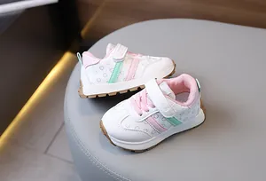 Detail of kids sneaker with velcro strap, pink accents and durable rubber sole