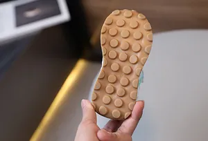 Detailed view of brown rubber non-slip sole with size 23 markings for kids sneakers