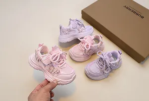 Close-up of pink and purple girls sneakers with sequin butterfly and pearl accents
