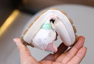 Close-up of flexible non-slip rubber sole on pink smiley face kids sneakers