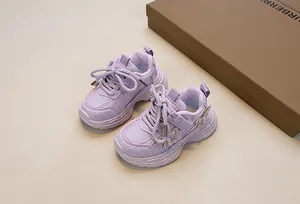 Detailed macro view of purple girls' sneaker featuring butterfly ornaments and pearls
