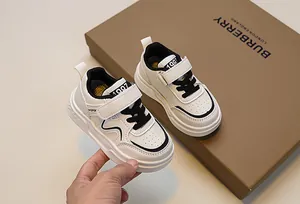 Detail of kids white sneaker featuring 1987 tongue label and sport velcro strap closure