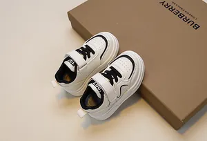 Macro view of kids' leather sneakers featuring velcro strap and breathable toe detail