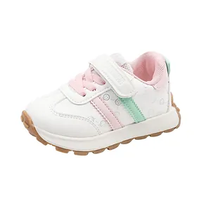 Kids sports sneaker in white and pink with durable rubber sole and velcro strap