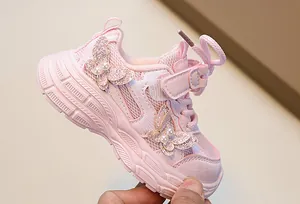 Detail of pink girls' sneaker with glitter butterfly, pearls and breathable mesh fabric