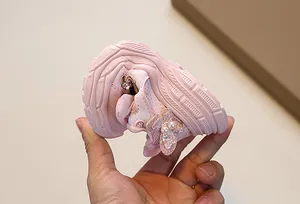 Close-up of flexible pink girls sneaker sole showing softness and high flexibility