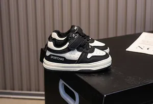 Detail view of children's sneakers with velcro and laces in black and white finish