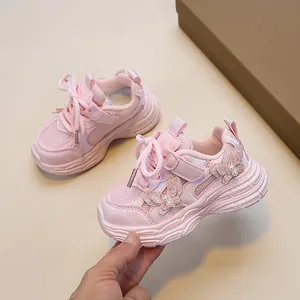 Pink girls' sneakers with butterfly sequins and breathable mesh panels in a stylish design