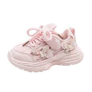 Pink girls dad sneakers with mesh fabric and glitter butterfly detail on white background