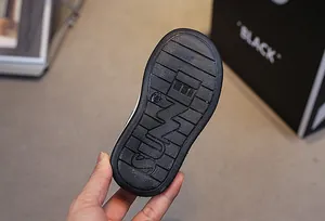 Close-up of flexible black rubber sole with anti-slip grip and size 23 mark