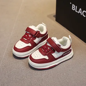 Classic red and white kids' sneakers with Velcro closure and breathable leather upper