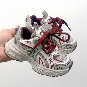 Close-up of kids dad shoes showing breathable mesh and burgundy laces detail