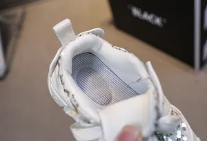 Detail of girls glitter sneakers showing breathable mesh insole and arch support pad