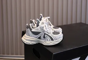 Close-up of children's mesh athletic shoe with chunky sole and grey color splicing detail