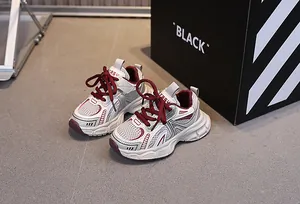 Detail of kids breathable mesh sneakers in red, white and grey with non-slip sole