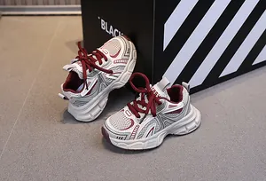 Close-up of breathable mesh fabric and burgundy lace details on children sneakers