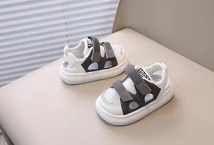 Detail of white mesh toddler sandals with double velcro straps and 1987 print