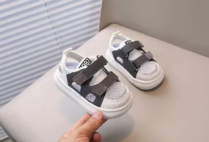 Detail of baby sports sandal with breathable grey mesh and double velcro straps
